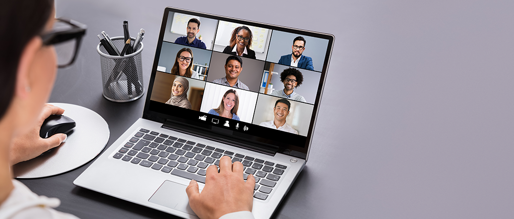 Person on laptop conversing with other participants 