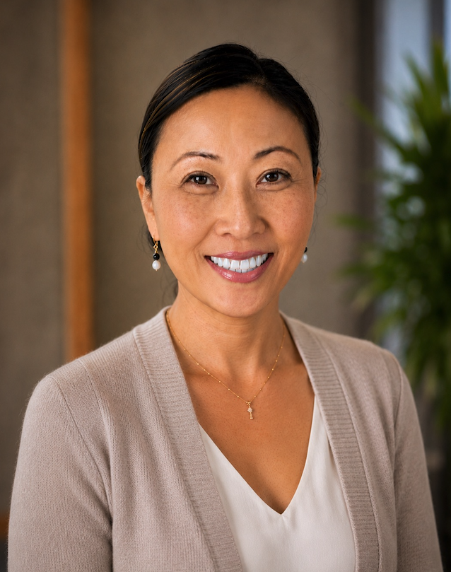 Head shot of East Asian female in a sand colour sweater