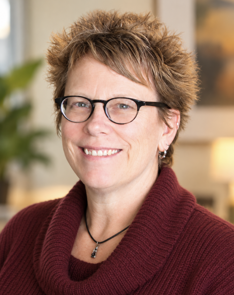 Headshot of woman with short hair and glasses
